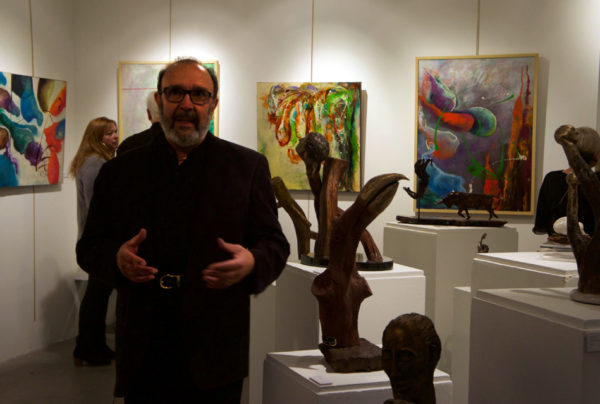 MARINO in front of his various bronze sculptures.